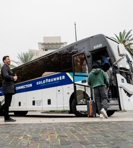 people boarding gold runner bus